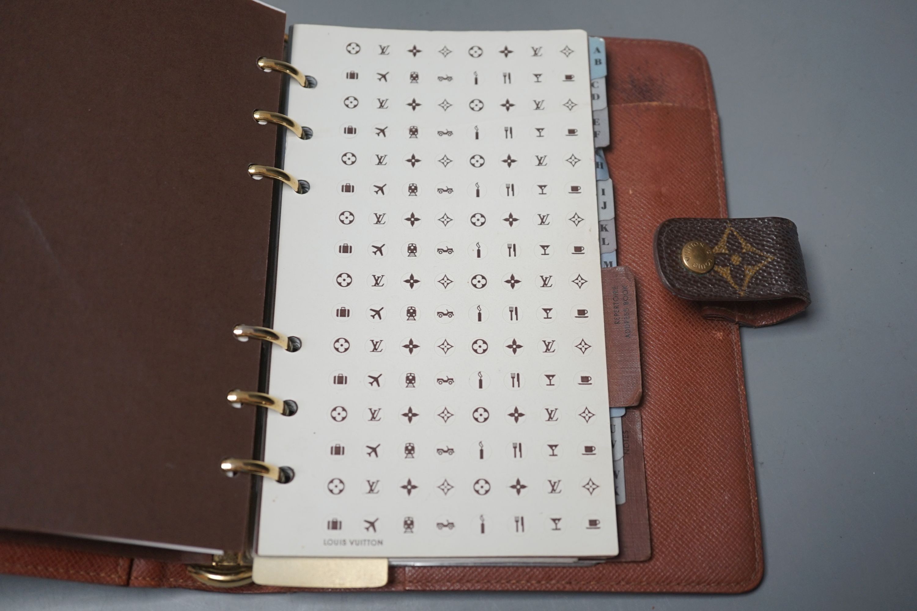 A leather Louis Vuitton brown monogram pattern repertoire agenda case, in original box